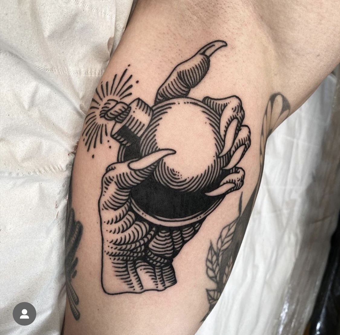 Devilish Hand Holding a Sparked Orb Tattoo Design