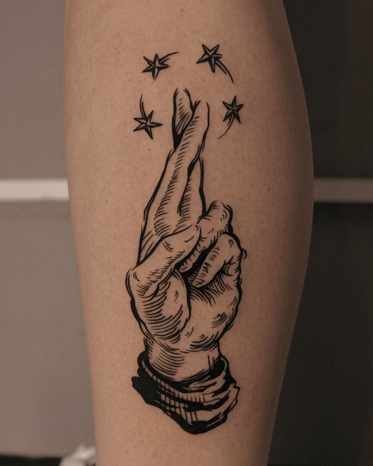 Starry Hand Gesture in Bold Blackwork Tattoo Design