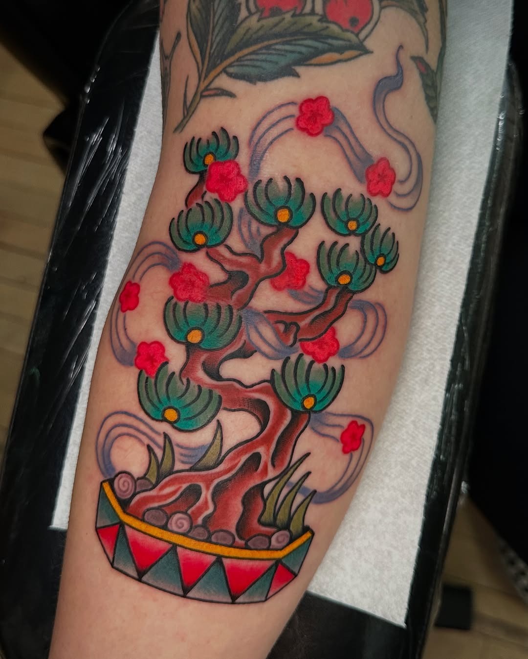 Vibrant Bonsai Tattoo with Floral Accents Tattoo Design