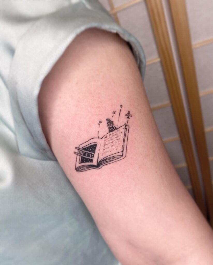 Open Book with Girl and Paper Airplane Tattoo Tattoo Design