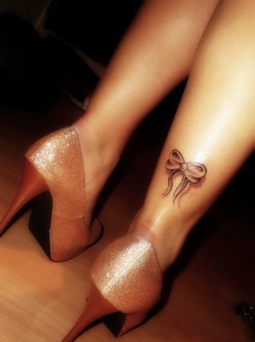 Cute detailed bow tattoo on a leg Tattoo Design