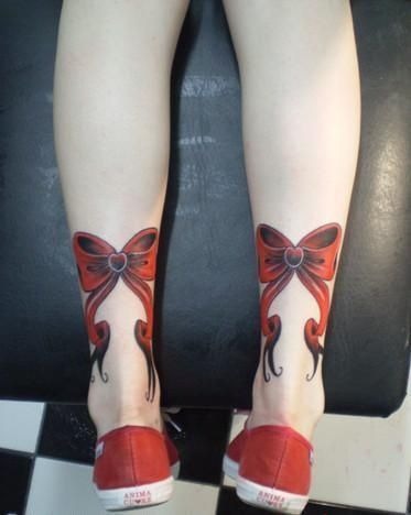Red bow tattoo design just above the heels Tattoo Design