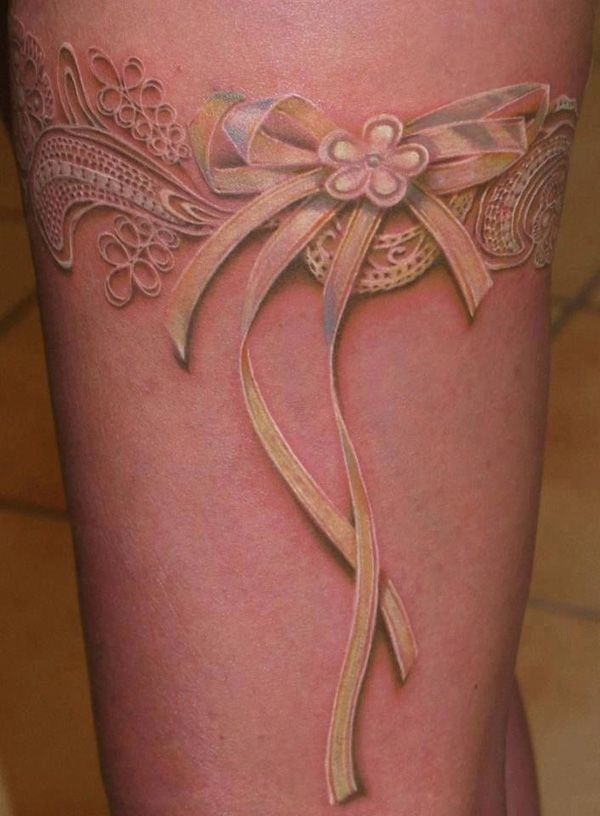 Skin-colored bow tattoo on an arm Tattoo Design