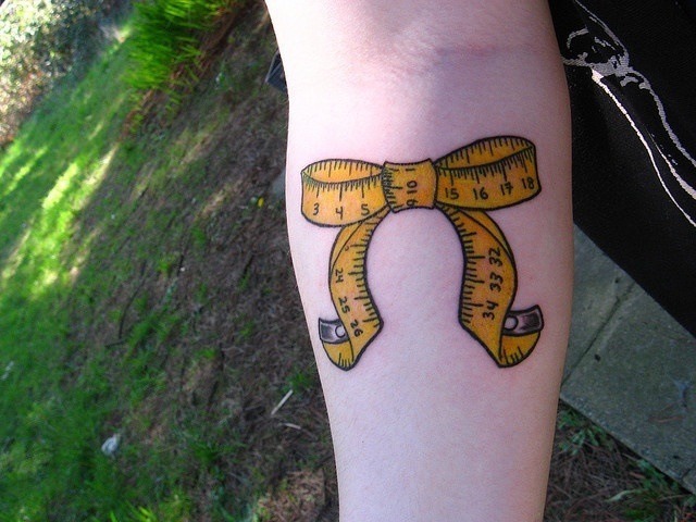 Yellow Measuring Tape Ribbon Tattoo Design