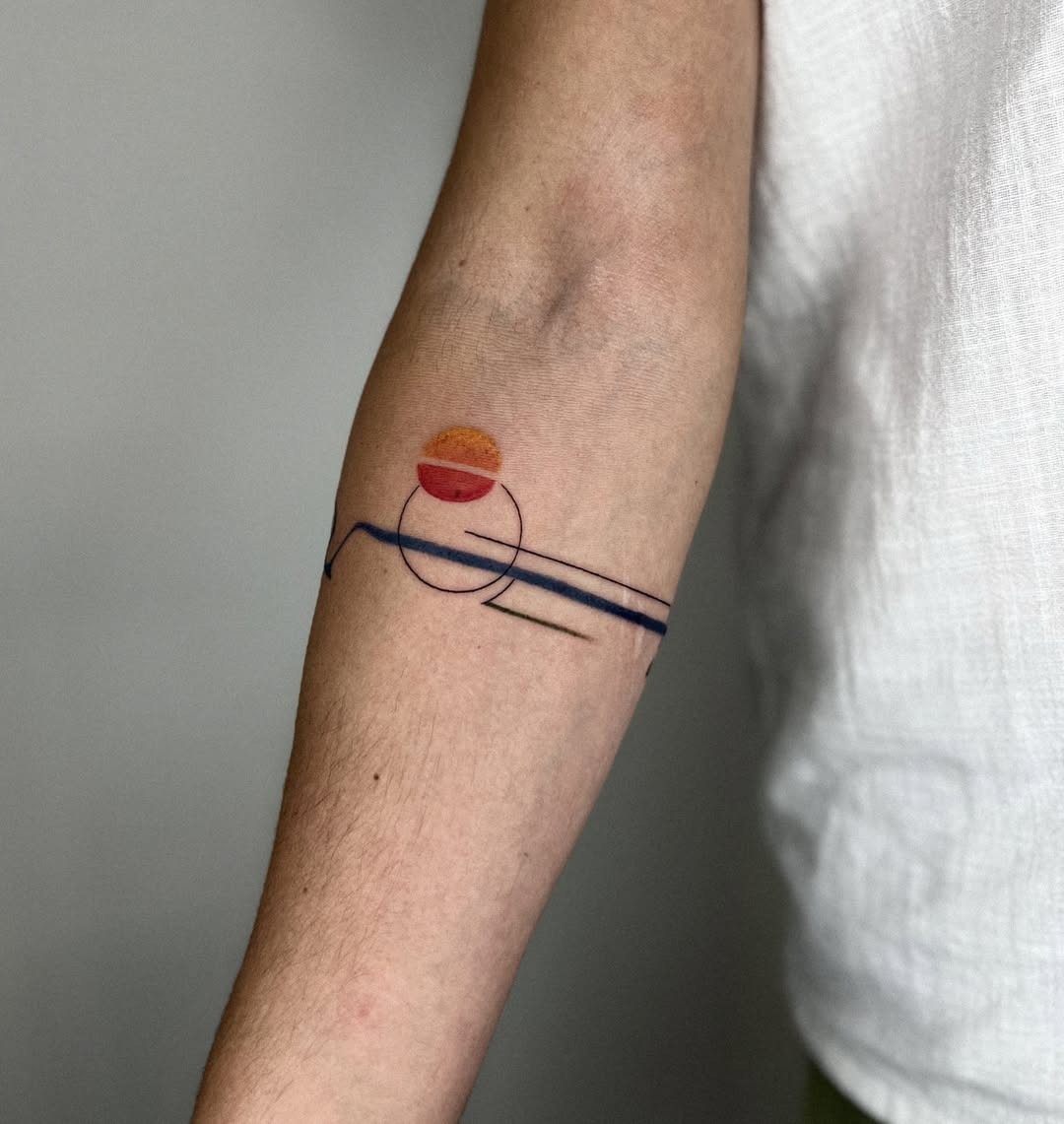 This tattoo features a vivid sunset with soft curves.