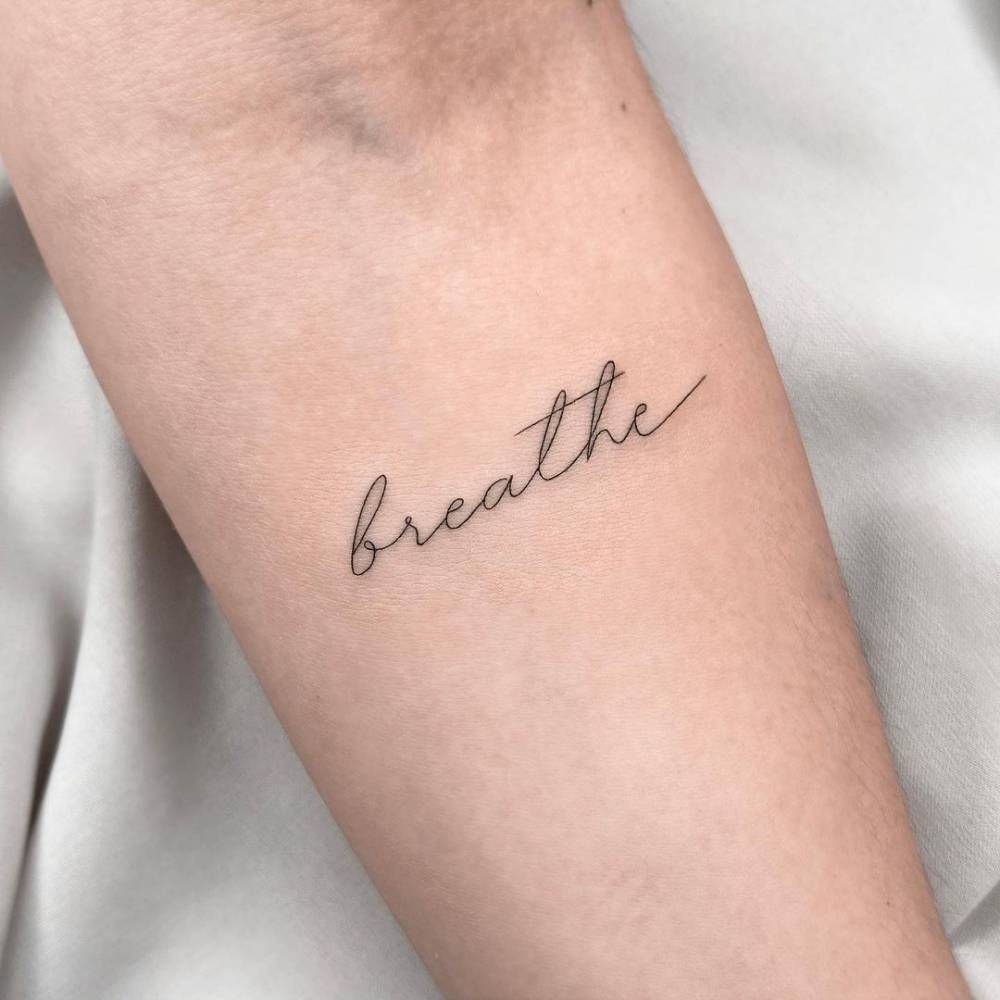 Simple Breathe Tattoo on Wrist in Script Tattoo Design