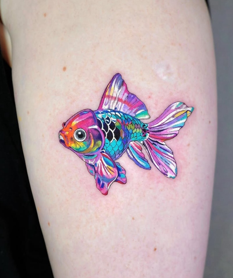This goldfish tattoo radiates energy and life with its stunning array of colors.