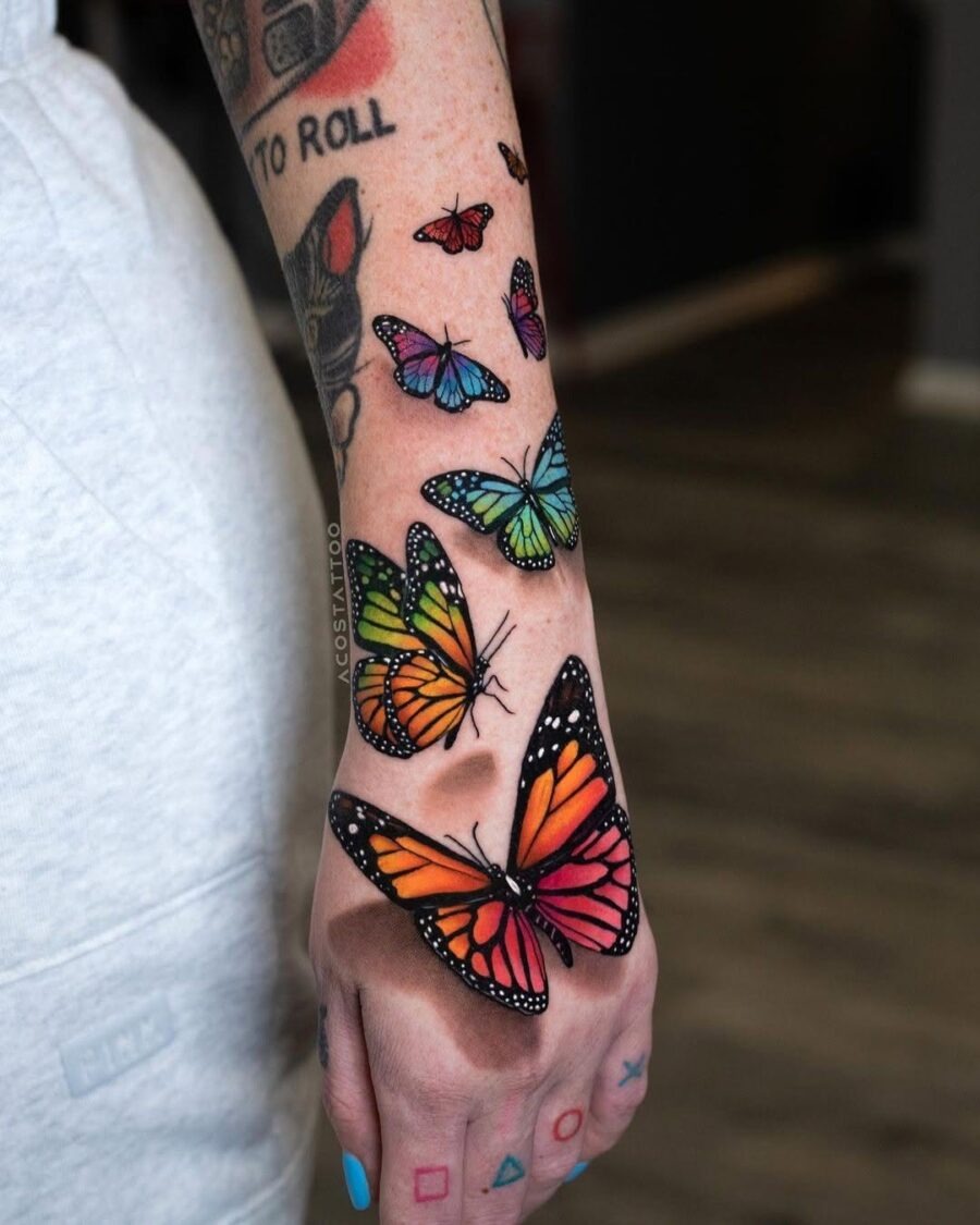 This image features an array of butterfly tattoos elegantly inked on the arm.