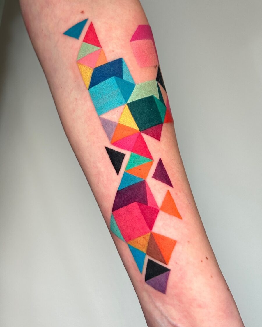 This tattoo features a stunning array of geometric shapes, bursting with bright colors.