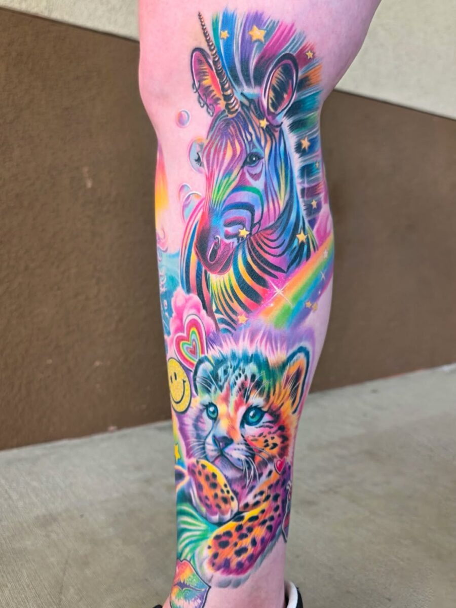 This leg tattoo showcases a playful mix of animal motifs, featuring a unicorn and a leopard cub.