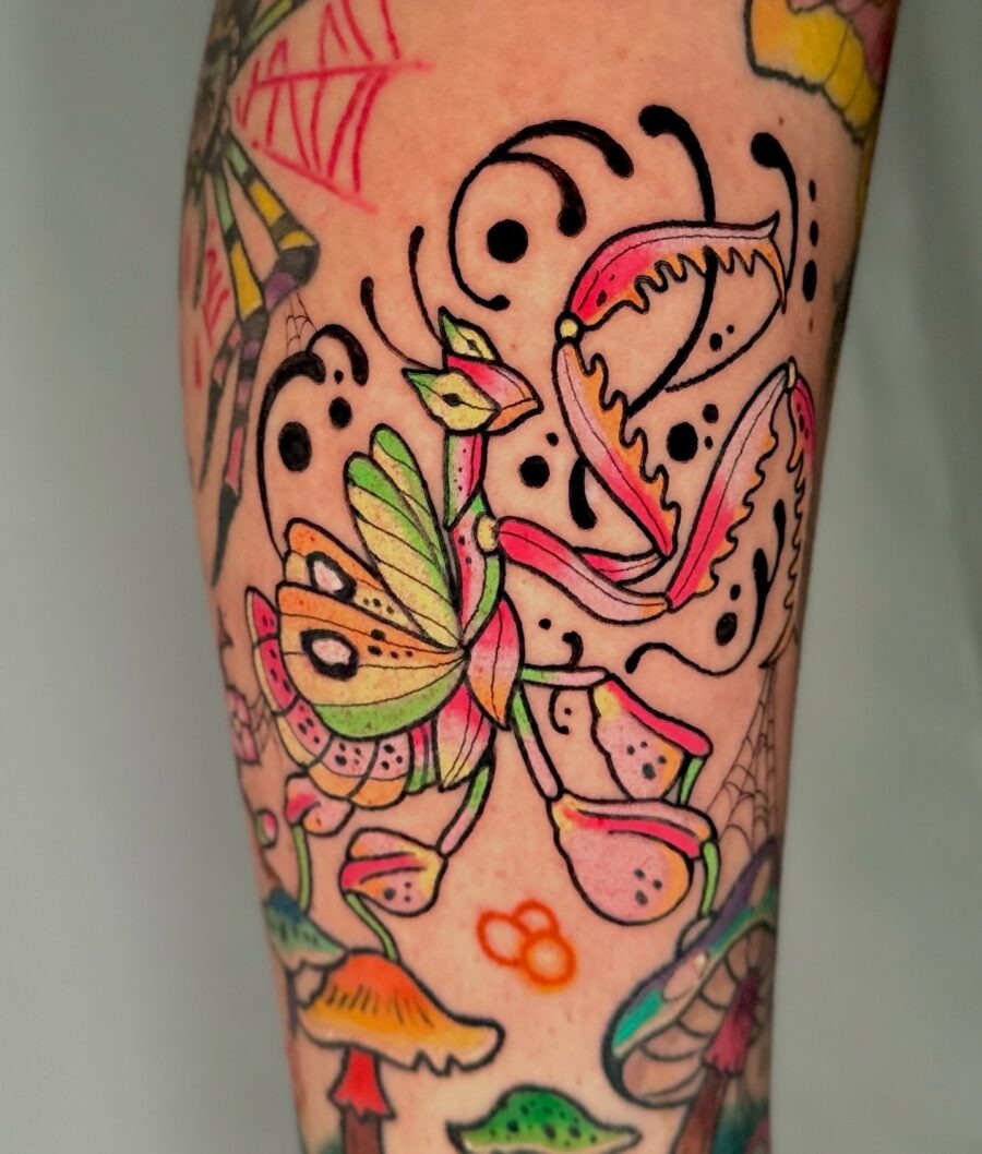 This captivating tattoo features a colorful floral design that bursts with energy.