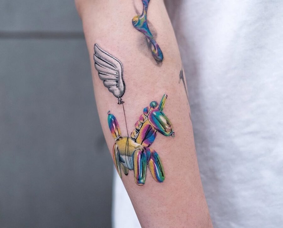 This tattoo showcases a whimsical unicorn that appears to be floating, marked by its colorful palette.