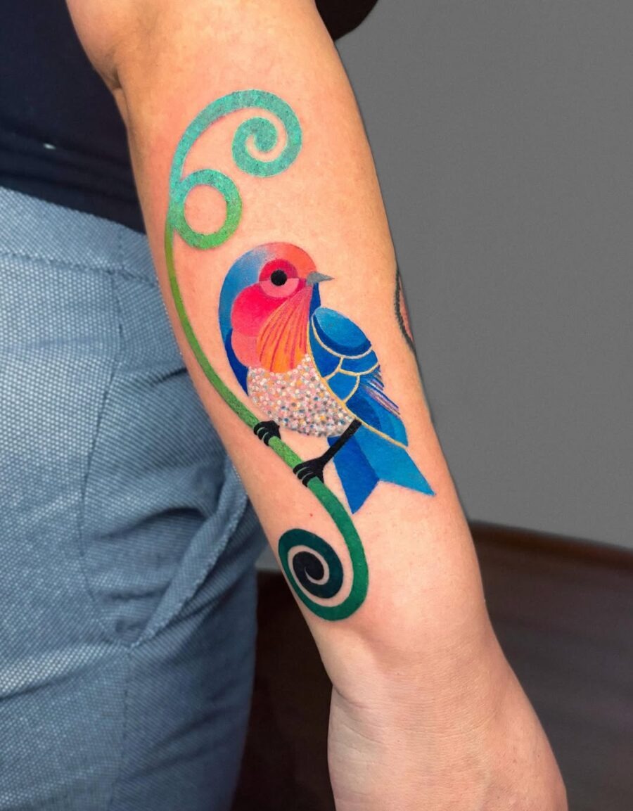 This bright-colored bird tattoo showcases a beautifully detailed design.