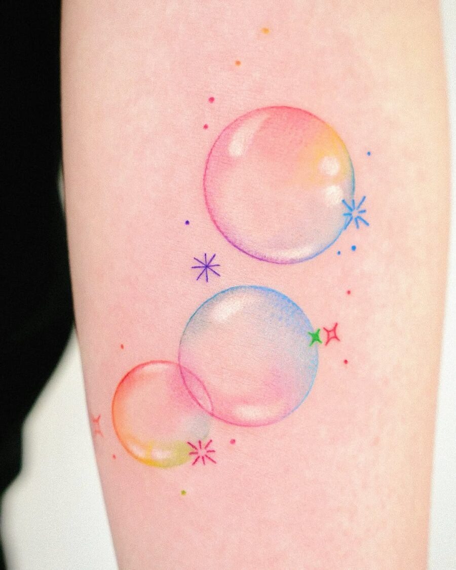 This tattoo features playful bubble designs in a spectrum of bright colors.