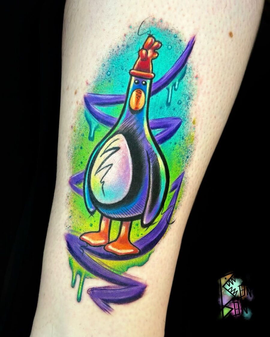 This colorful tattoo features a charming cartoon pigeon with playful details.