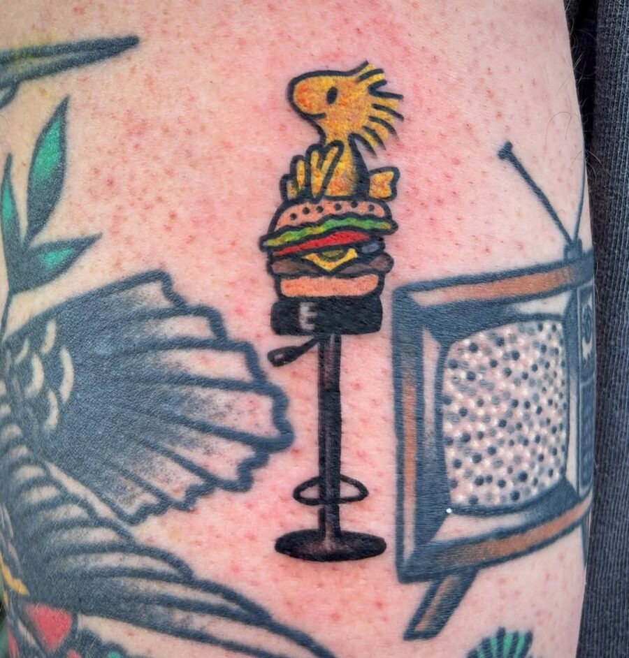 A playful burger tattoo with a cute character Tattoo Design