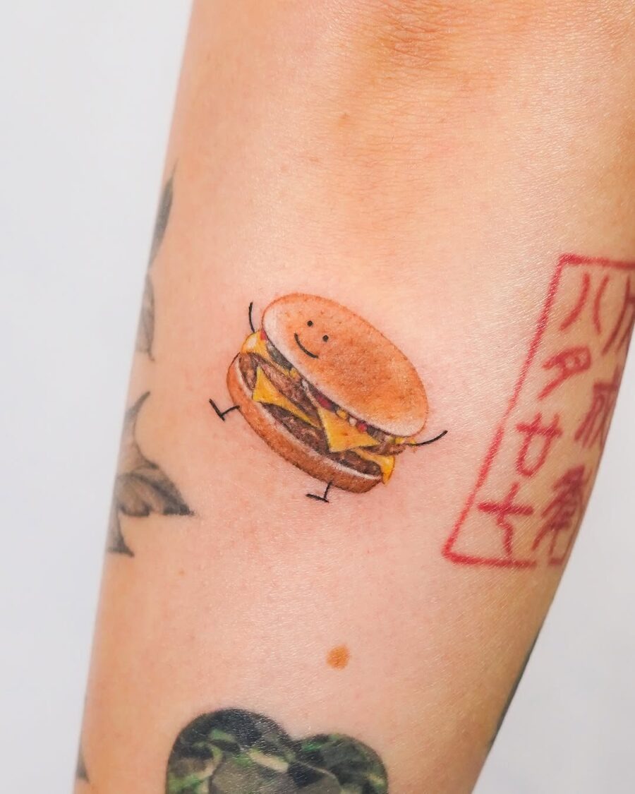 Adorable smiling burger tattoo on an arm Tattoo Design