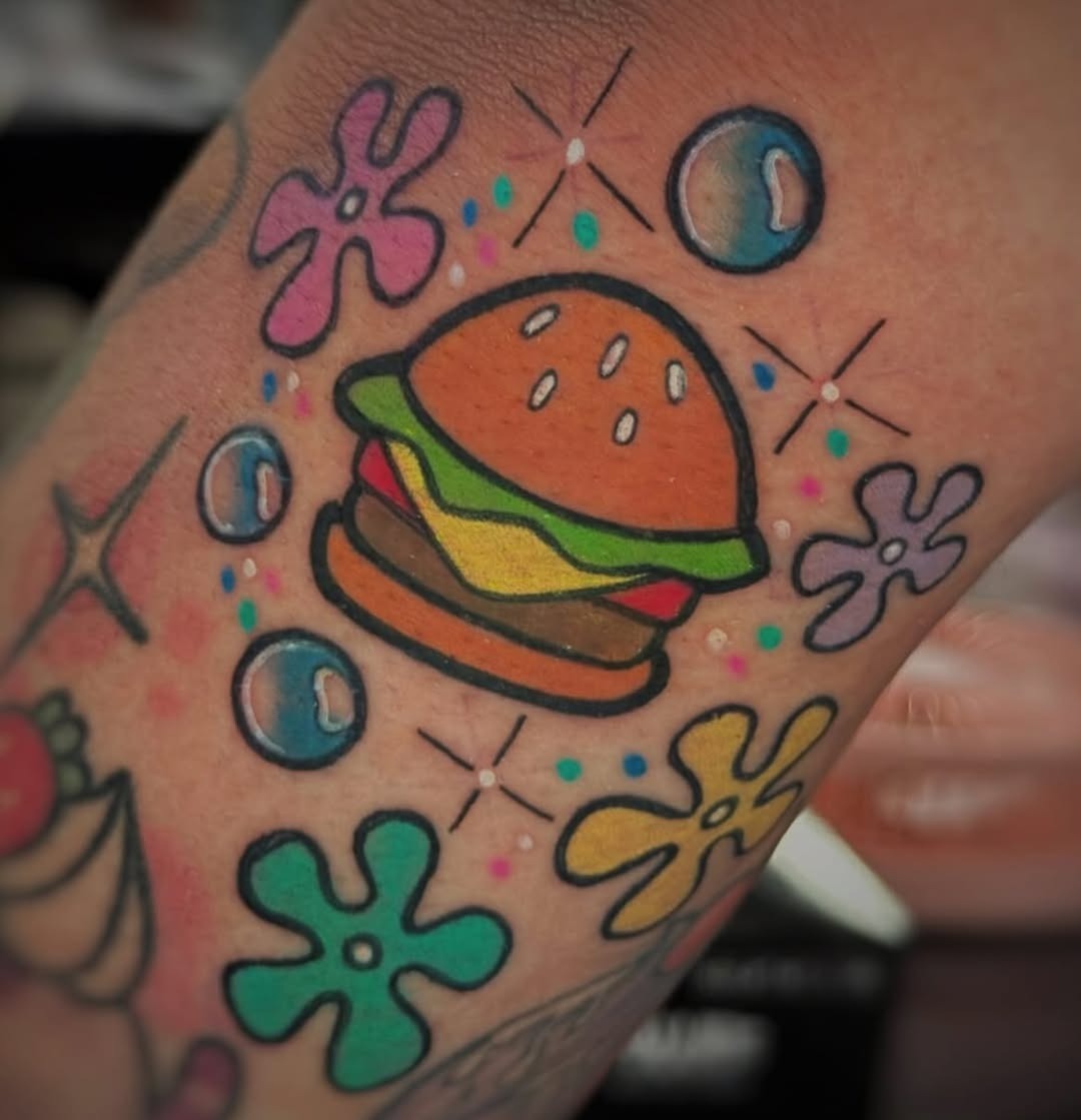 Playful burger tattoo with colorful accents Tattoo Design