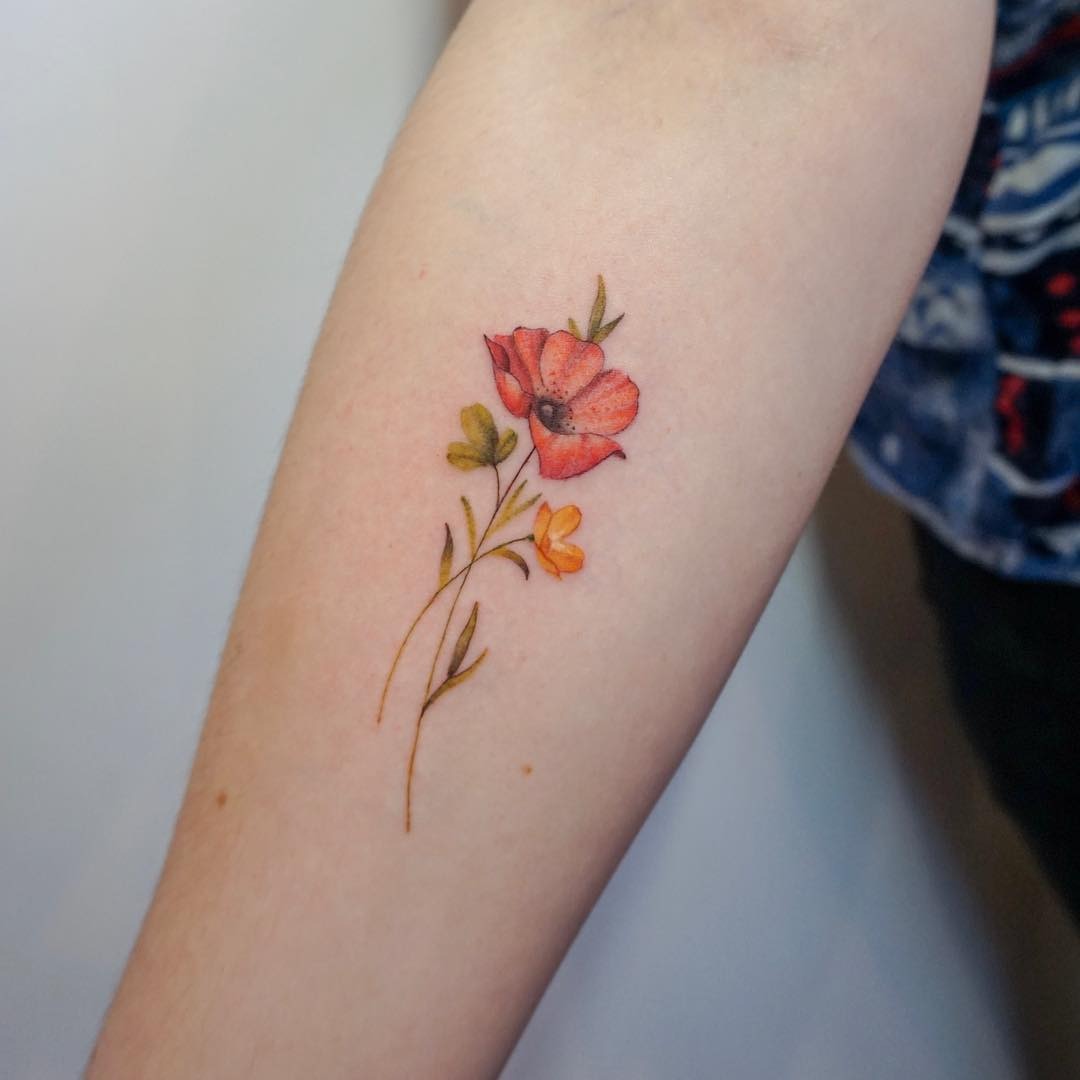 This tattoo features a beautifully buttercup flower, enhancing the forearm with its delicate details.