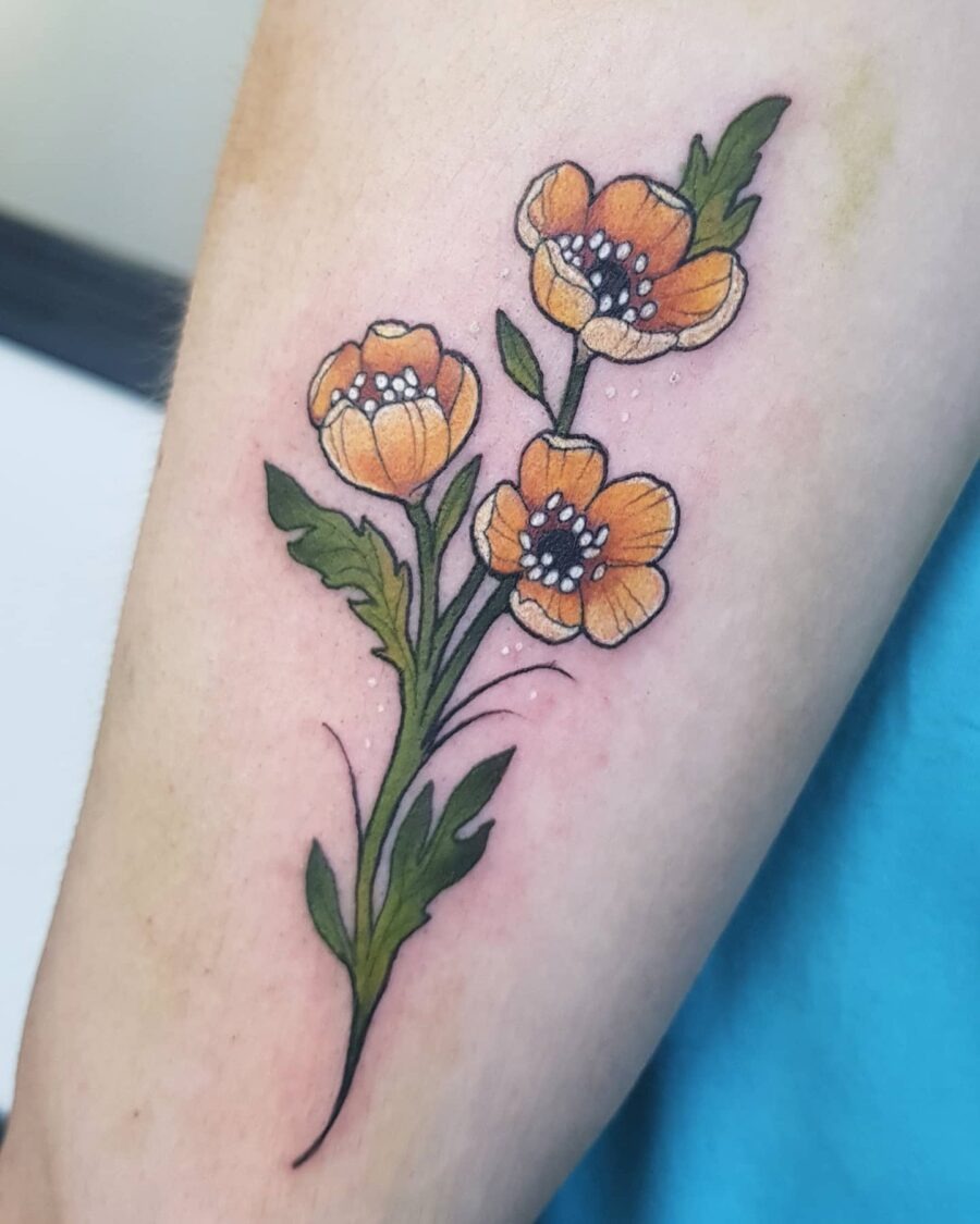 This beautiful tattoo features buttercup flowers in shades of yellow and orange.