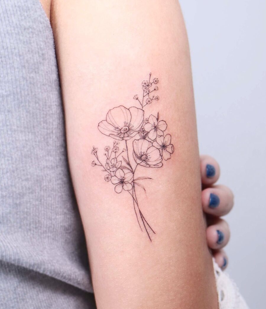 This minimalist tattoo beautifully showcases buttercup flowers in fine line art.