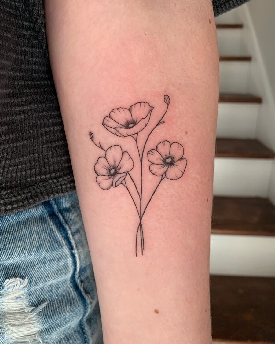 This tattoo features a delicate arrangement of buttercup flowers, showing their charming petals and slender stems.