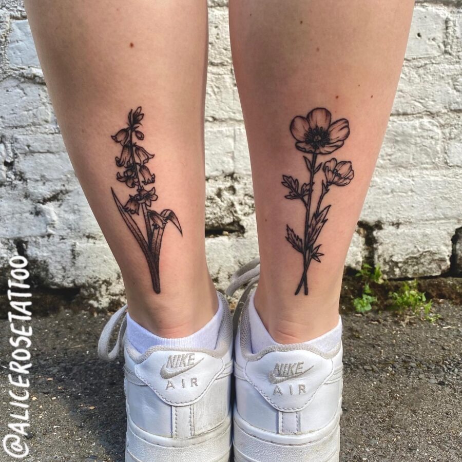 These tattoos showcase delicate buttercup flowers inked on the legs.