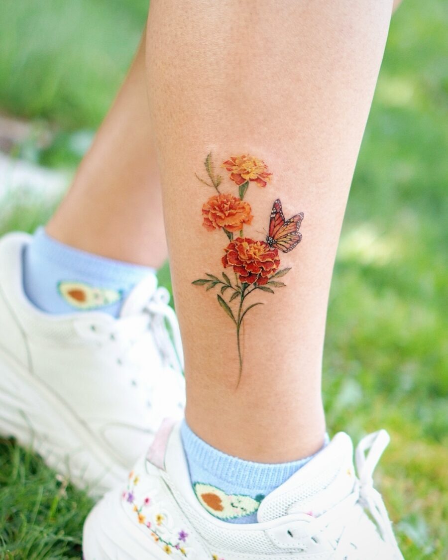 This tattoo showcases bright buttercup flowers with rich orange hues.