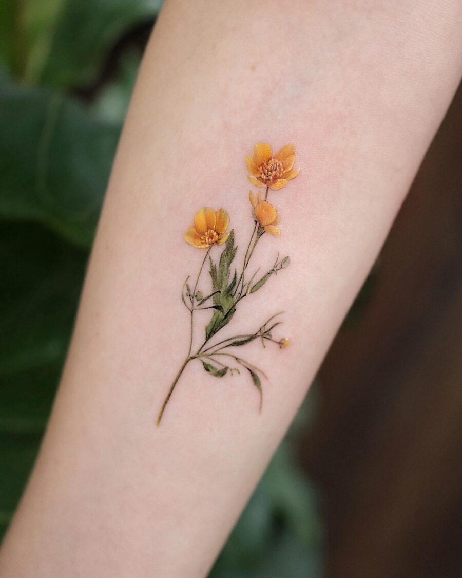 This beautiful buttercup flower tattoo features bright yellow blossoms that evoke cheerfulness.