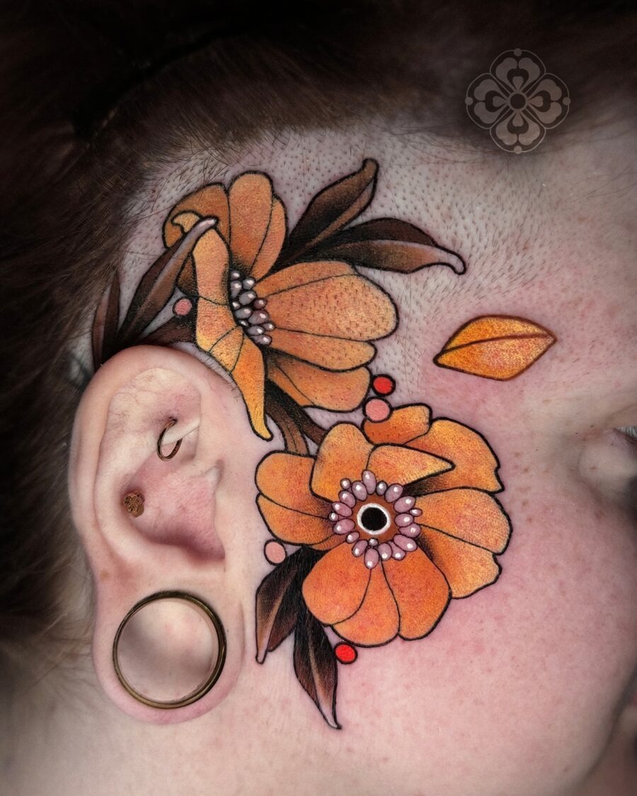 This buttercup flower tattoo features orange blooms with intricate detailing.