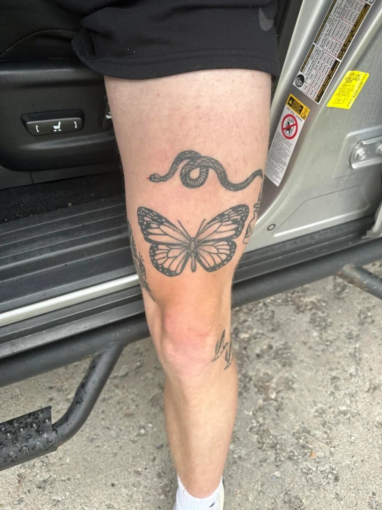 Bold Butterfly and Snake Design on the Thigh Tattoo Design