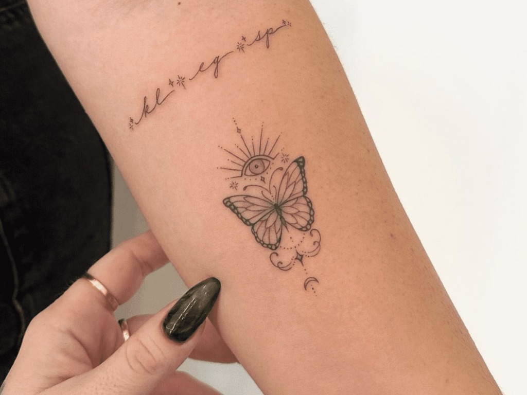 Intricate Butterfly and Script Design on the Forearm Tattoo Design