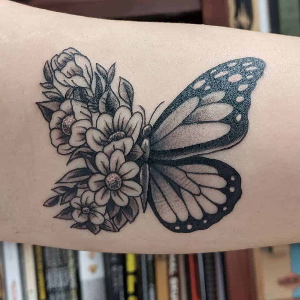 Monochrome Butterfly with Floral Details on the Arm Tattoo Design
