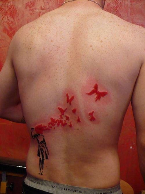 A beautifully decorated butterfly on the back tattoo, detailed design on the back.