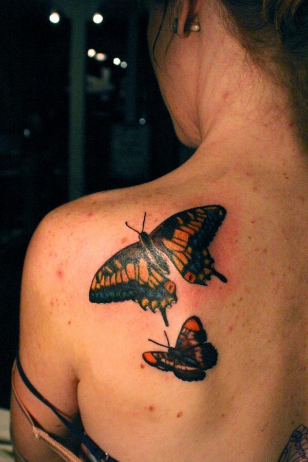 A bluish butterfly on the arm tattoo, detailed design on the arm.
