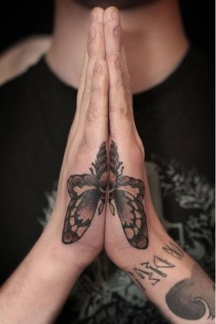 Brown-Black Butterfly Side-Hand tattoo, detailed design on the hand.