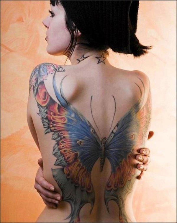 A large dark butterfly on the arm tattoo, detailed design on the ankle.