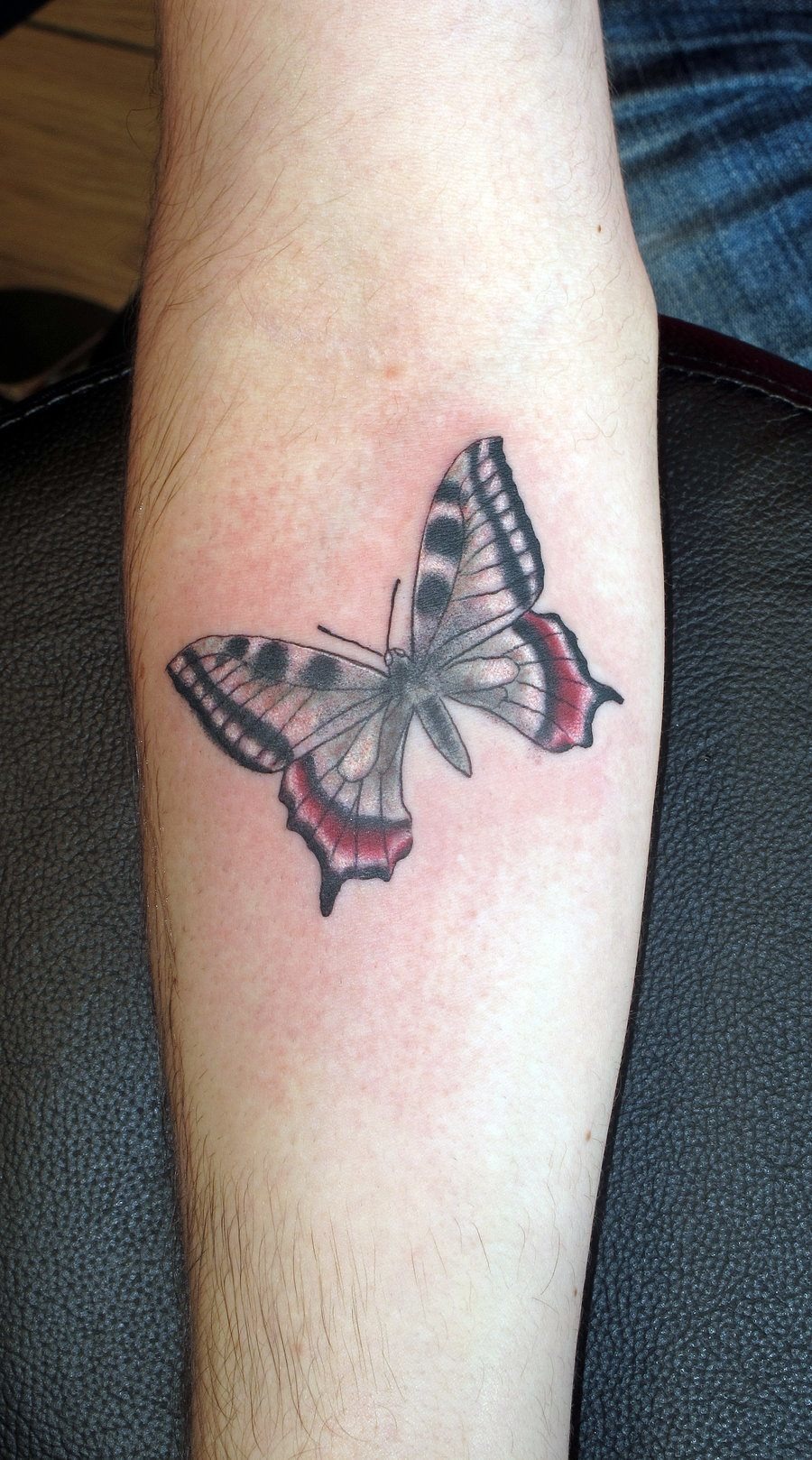 Butterfly with Vibrant Colors tattoo, bold design on the forearm.
