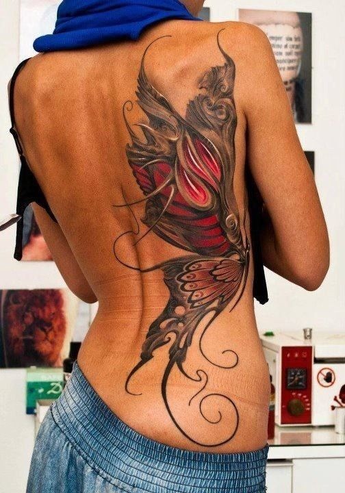 Colored butterfly tattoo, detailed design on the shoulder.