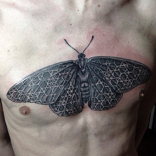 Moth Sprawled on Guy's Chest tattoo, detailed design on the chest.