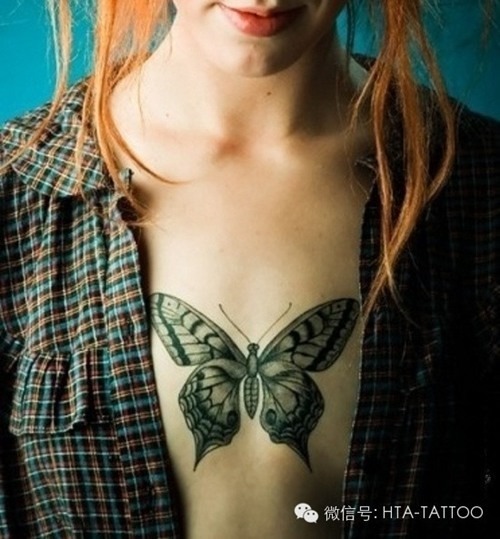 Small butterfly on a girl's side tattoo, detailed design.