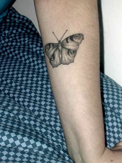 Black Monarch Butterfly on Forearm tattoo, detailed design on the arm.