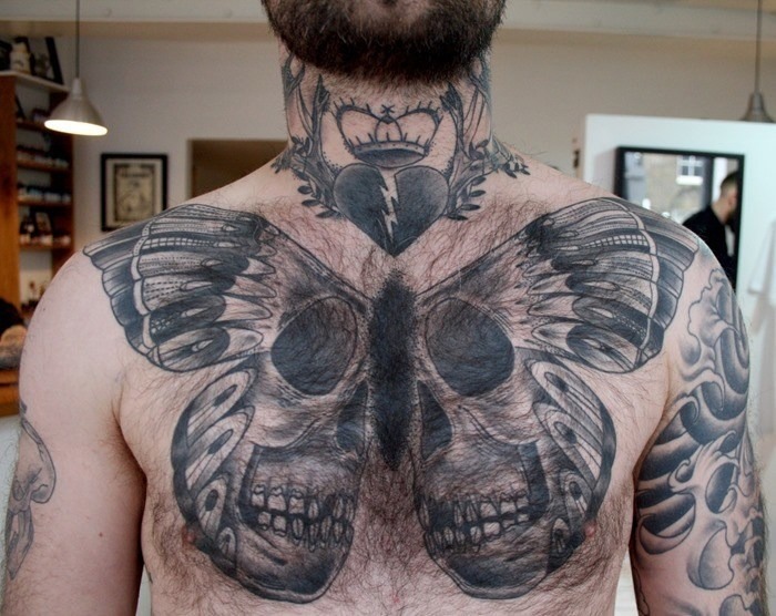 Huge Life-Death Butterfly Hovers Over Chest tattoo, detailed design on the chest.