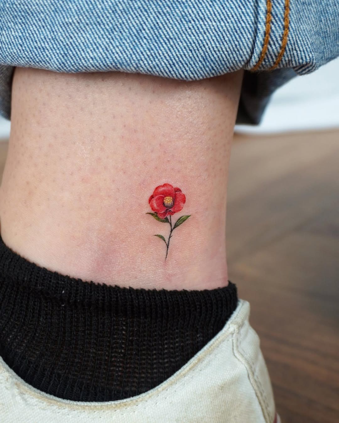 Charming camellia tattoo on ankle Tattoo Design