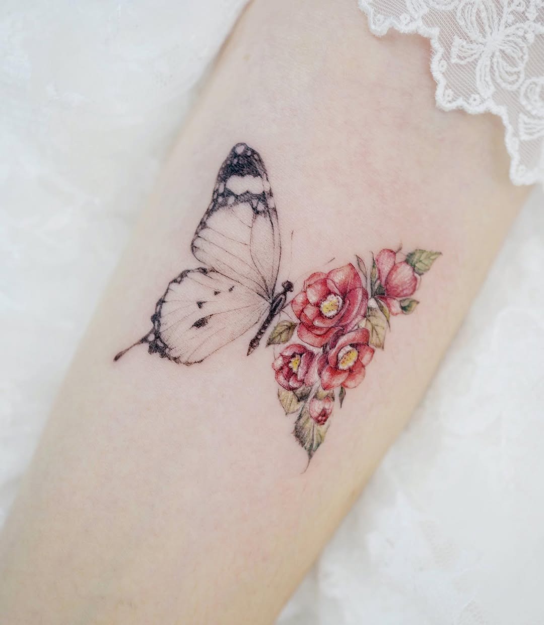 Delicate butterfly and camellia flower tattoo design Tattoo Design