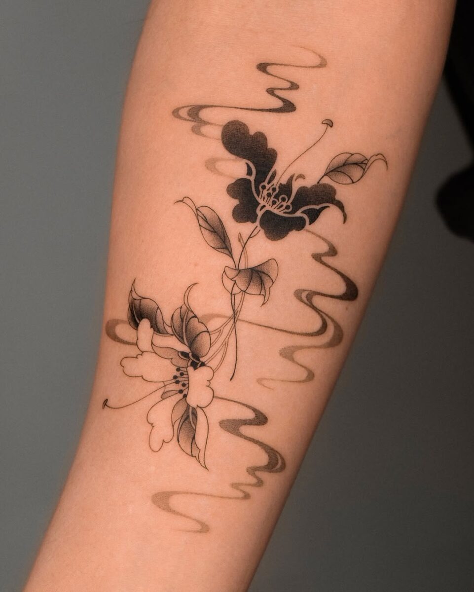 Elegant black camellia tattoo with flowing lines Tattoo Design