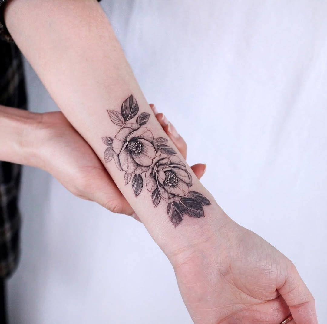 Elegant camellia tattoo design on forearm Tattoo Design
