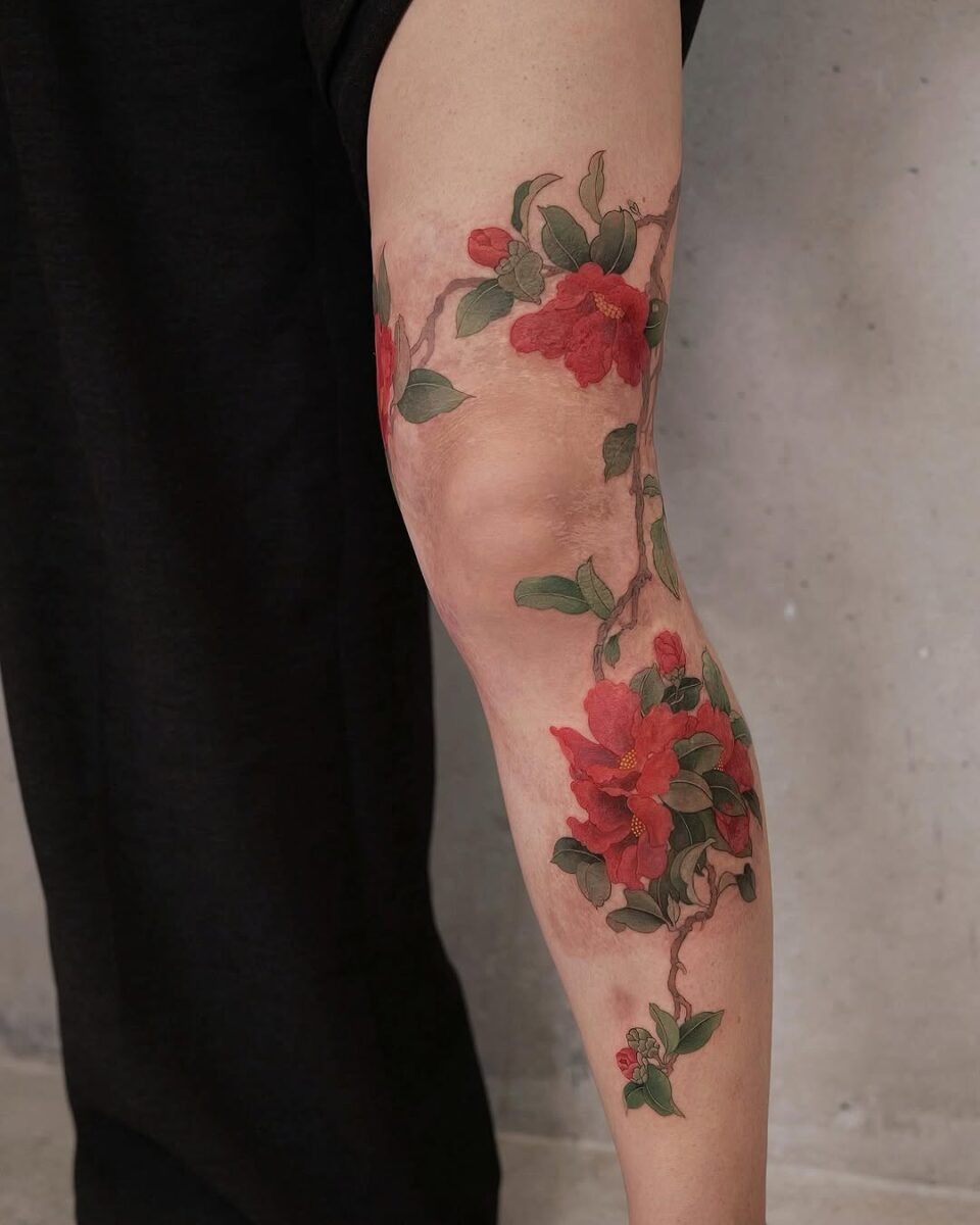Elegant camellia tattoo with rich colors Tattoo Design