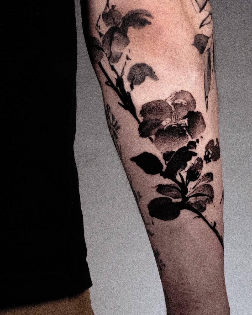 Stunning Camellia Tattoo in Bold Black Ink Tattoo Design