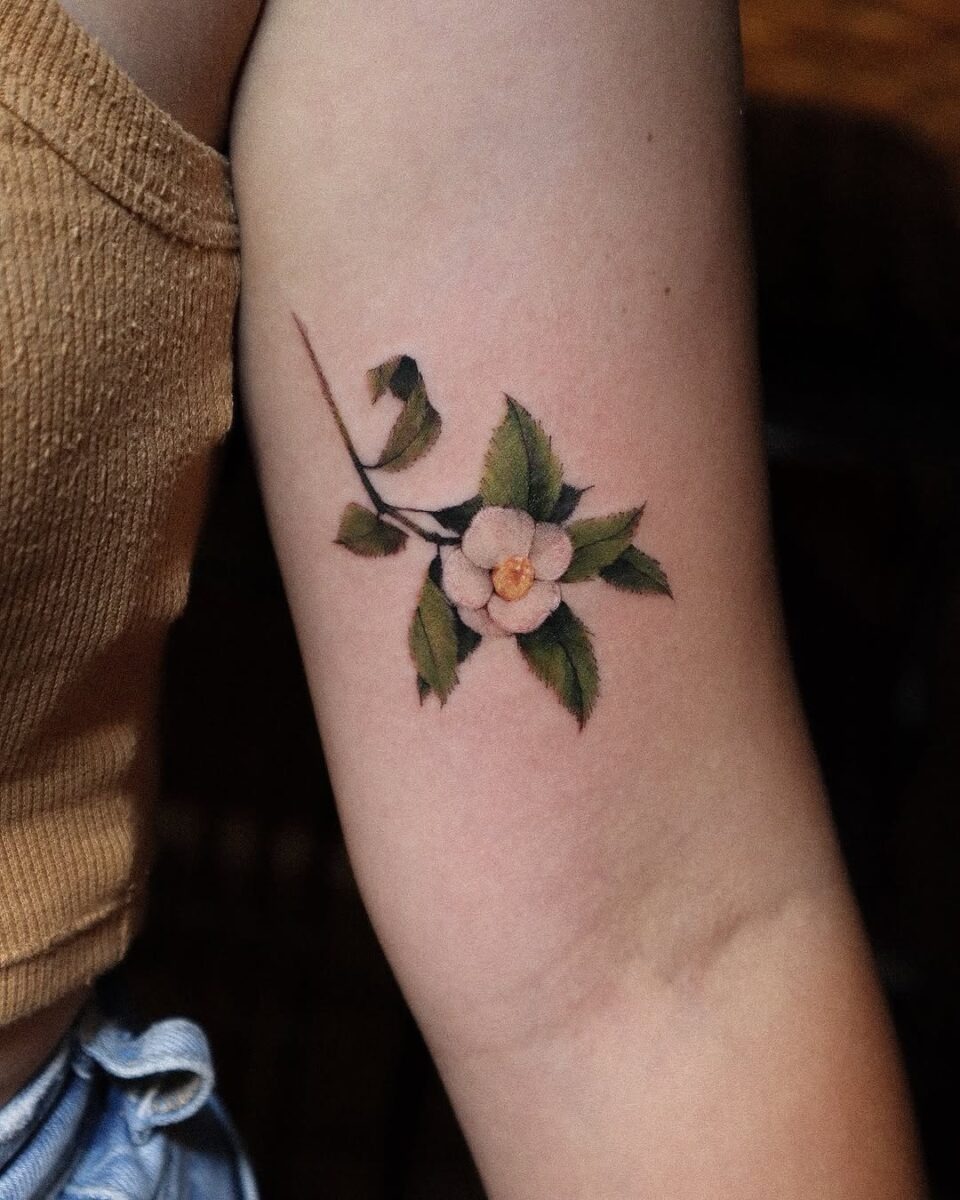 Stunning camellia tattoo on the arm Tattoo Design